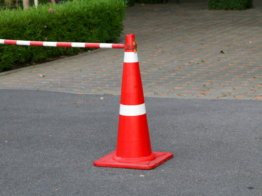 OPTSIGNS | Retractable Belt vs. Cone Bars: Which Traffic Cone Barrier System Is Right for You?